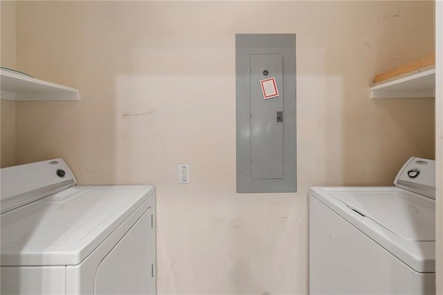 washroom featuring electric panel and washer and dryer