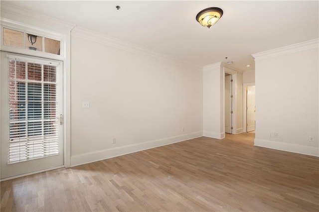 empty room featuring hardwood / wood-style flooring and crown molding