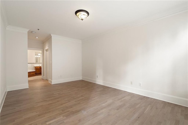 unfurnished room featuring hardwood / wood-style flooring and crown molding