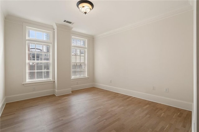 unfurnished room featuring ornamental molding and wood-type flooring