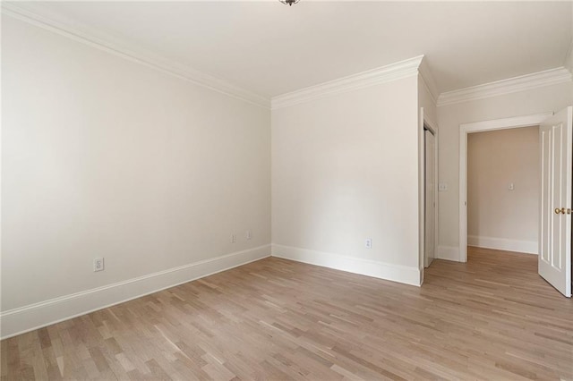 empty room featuring crown molding and light hardwood / wood-style flooring