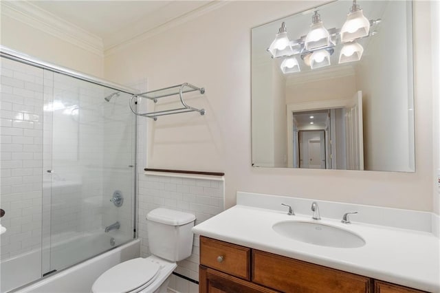 full bathroom with crown molding, vanity, bath / shower combo with glass door, and toilet