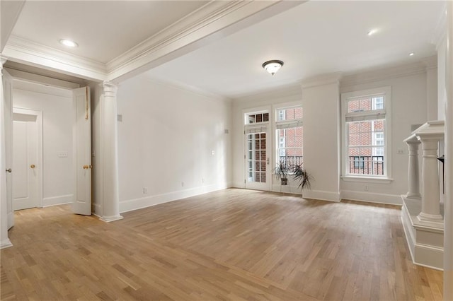 unfurnished living room with crown molding, decorative columns, and light wood-type flooring