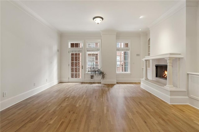 unfurnished living room with hardwood / wood-style floors and ornamental molding