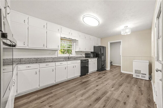 4218 Hideaway Dr, Tucker, GA 30084 - kitchen with a sink, white cabinetry, black appliances, and light wood finished floors
