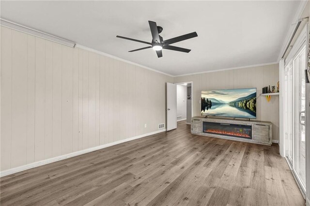 4218 Hideaway Dr, Tucker, GA 30084 - living room featuring crown molding, baseboards, ceiling fan, a glass covered fireplace, and wood finished floors