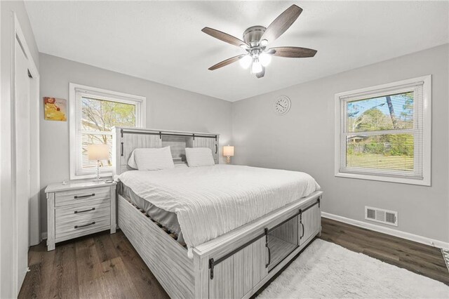 4218 Hideaway Dr, Tucker, GA 30084 - bedroom featuring baseboards, dark wood-style flooring, ceiling fan, and visible vents
