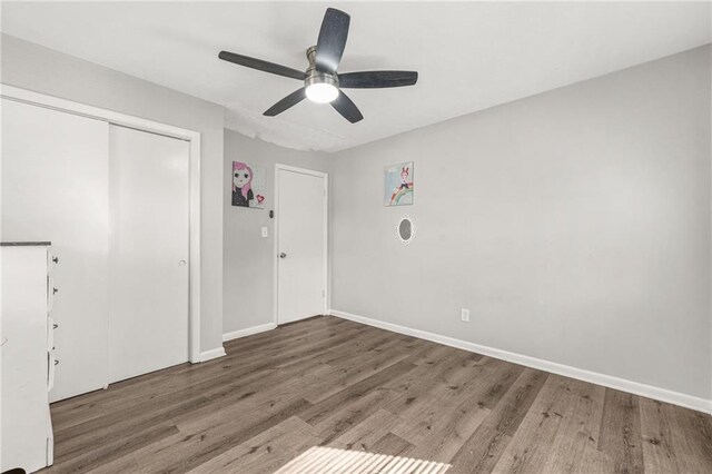 4218 Hideaway Dr, Tucker, GA 30084 - unfurnished bedroom with baseboards, a closet, ceiling fan, and wood finished floors