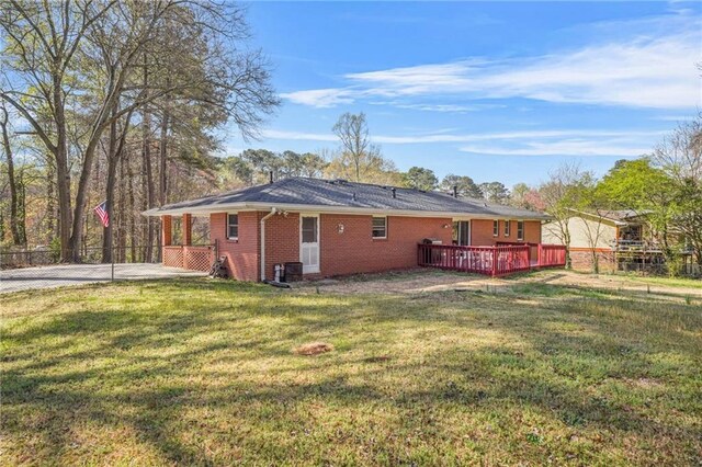 4218 Hideaway Dr, Tucker, GA 30084 - rear view of property featuring a lawn, brick siding, fence, and a wooden deck