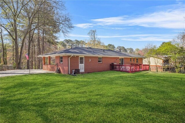 4218 Hideaway Dr, Tucker, GA 30084 - rear view of property featuring a lawn, a wooden deck, fence, and brick siding