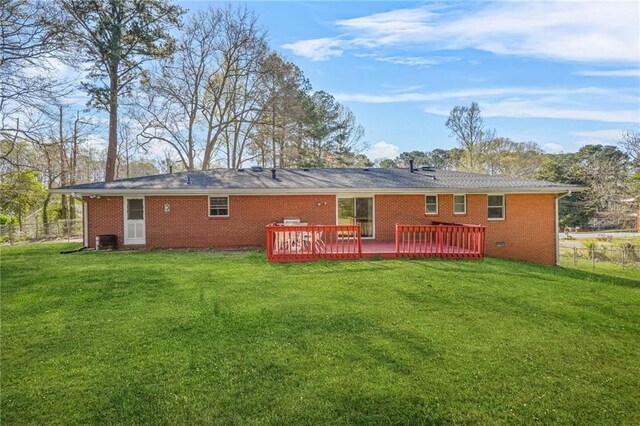 4218 Hideaway Dr, Tucker, GA 30084 - rear view of property featuring fence, a deck, brick siding, central AC, and a yard