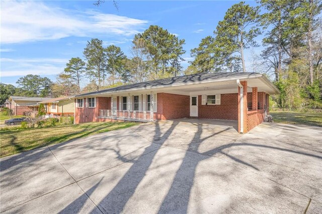 4218 Hideaway Dr, Tucker, GA 30084 - single story home with a front lawn, a carport, brick siding, and concrete driveway