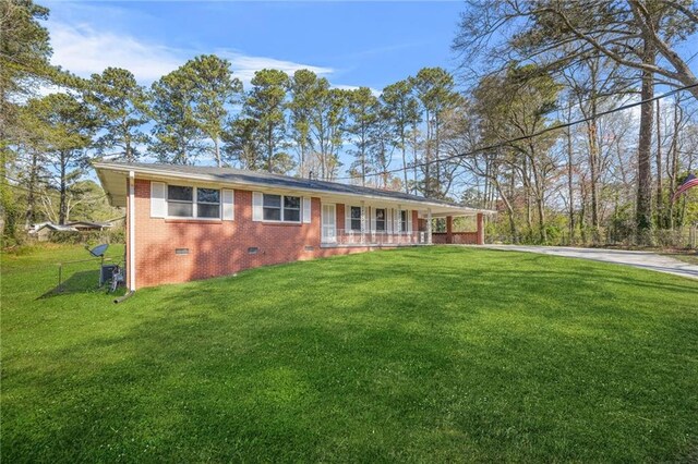 4218 Hideaway Dr, Tucker, GA 30084 - view of front facade with crawl space, brick siding, a front lawn, driveway, and a porch