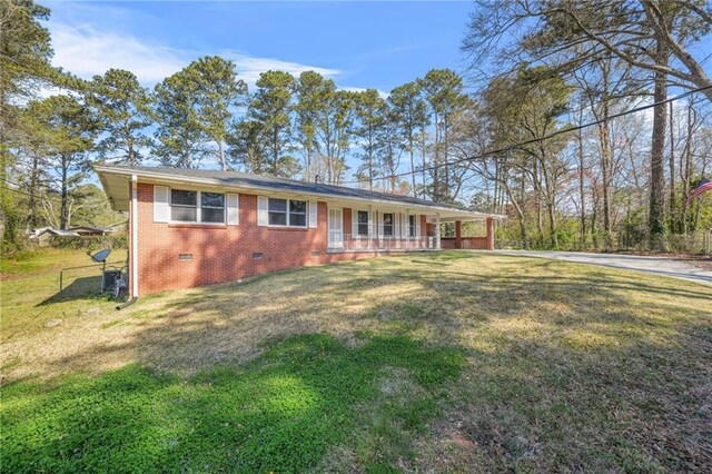 4218 Hideaway Dr, Tucker, GA 30084 - view of front of property featuring a front yard, an attached carport, brick siding, crawl space, and a porch