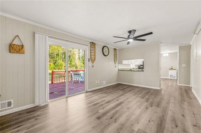 4218 Hideaway Dr, Tucker, GA 30084 - unfurnished living room featuring crown molding, baseboards, visible vents, ceiling fan, and wood finished floors
