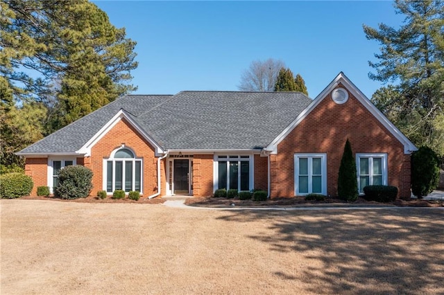 view of front of property featuring a shingled roof