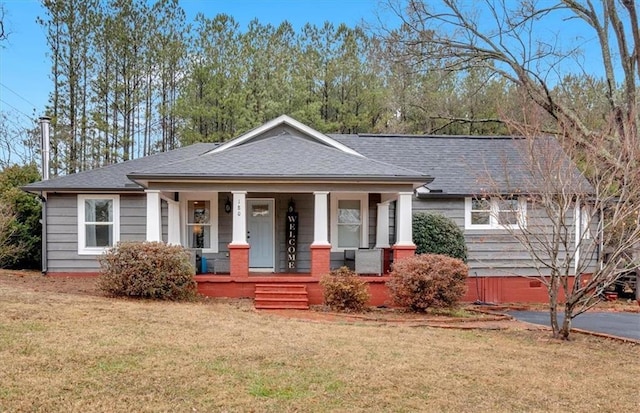 view of front facade with a front lawn and a porch