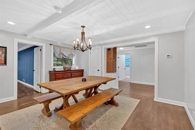 dining room featuring an inviting chandelier, dark wood-type flooring, ornamental molding, and beam ceiling