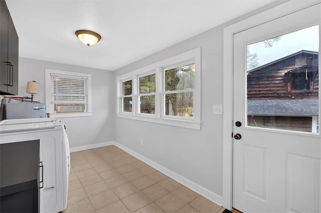 laundry area featuring light tile patterned floors and water heater