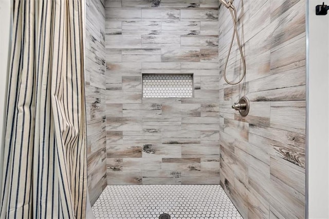 bathroom with a tile shower