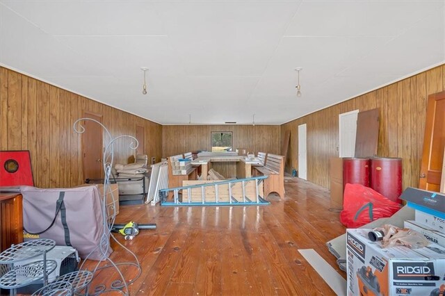 misc room featuring hardwood / wood-style floors and wooden walls