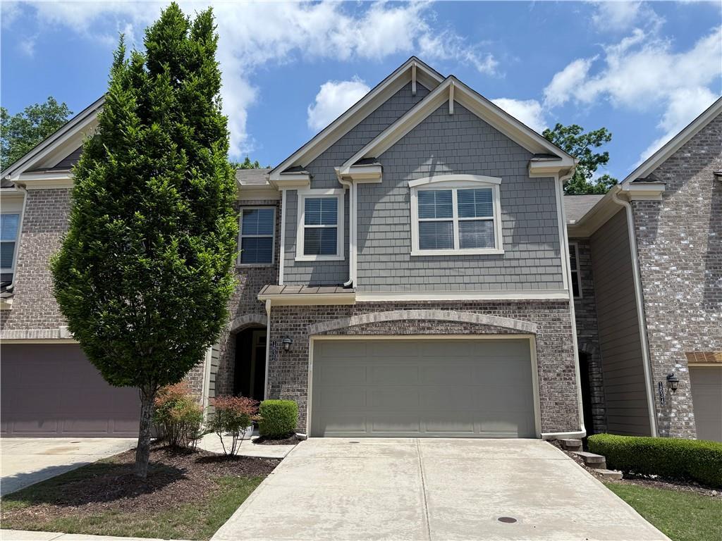 1632 Lenox Overlook Rd NE, Brookhaven, GA 30329 - craftsman-style home featuring concrete driveway, a garage, and brick siding