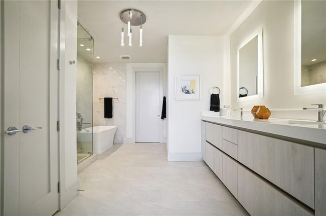 bathroom featuring vanity and separate shower and tub