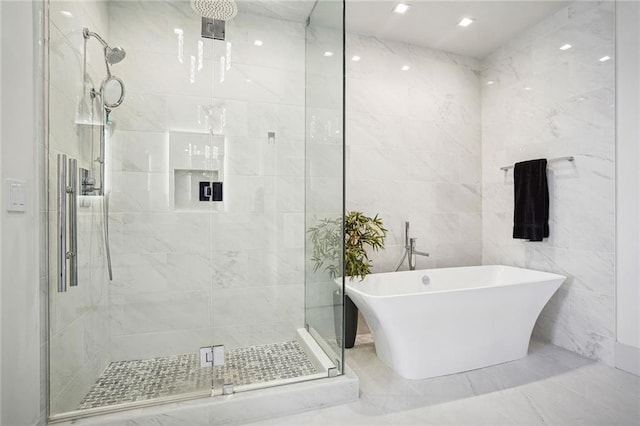 bathroom with shower with separate bathtub