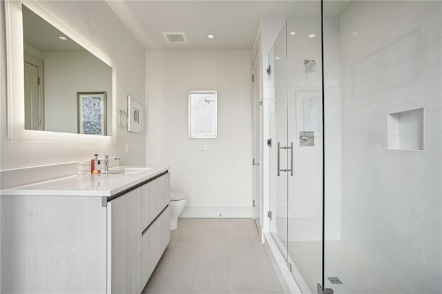 bathroom featuring vanity, an enclosed shower, tile patterned flooring, and toilet