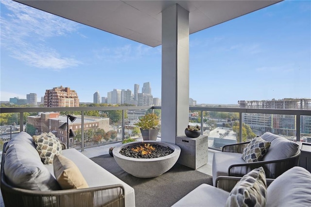 balcony with an outdoor living space with a fire pit