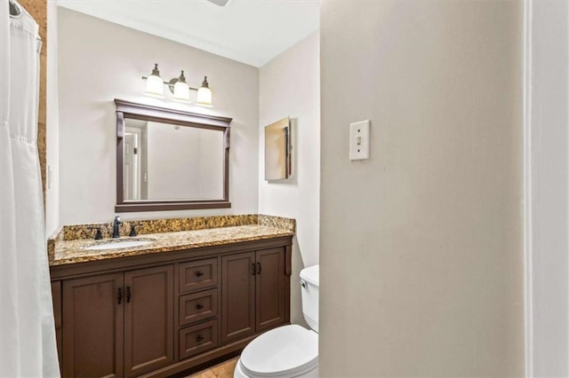 full bathroom featuring vanity and toilet