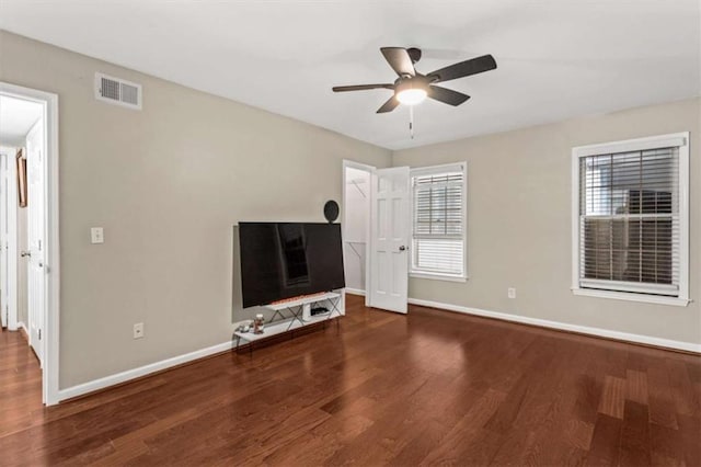 unfurnished living room with wood finished floors, ceiling fan, and baseboards