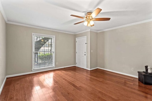 unfurnished room featuring wood finished floors, crown molding, ceiling fan, and baseboards