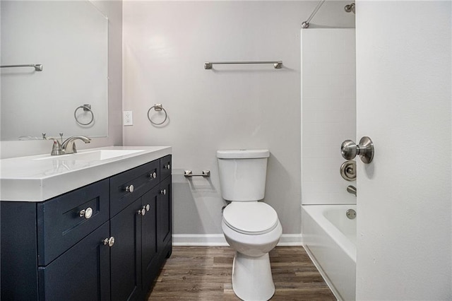 full bathroom featuring vanity, toilet, baseboards, tub / shower combination, and wood finished floors