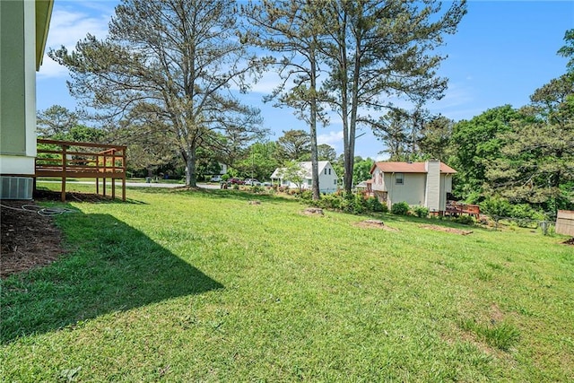 view of yard featuring a deck and central AC