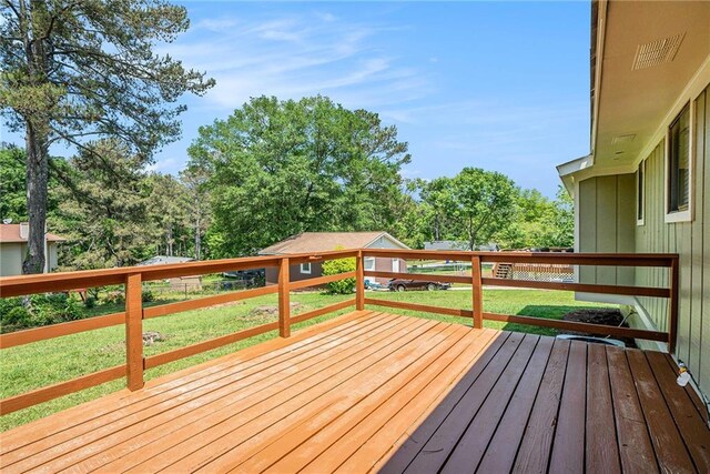 wooden deck with a lawn