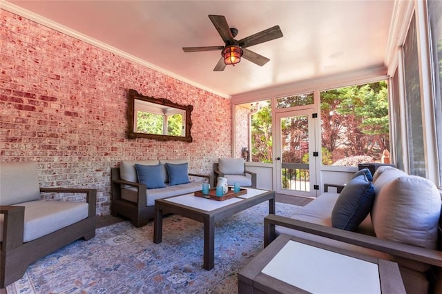 sunroom featuring crown molding and brick wall