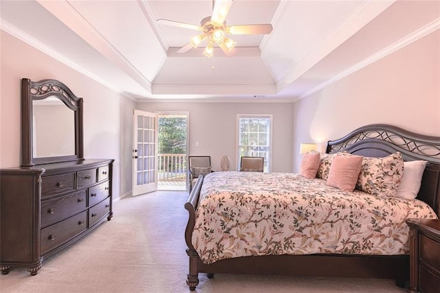 bedroom featuring light carpet, access to exterior, a tray ceiling, crown molding, and ceiling fan