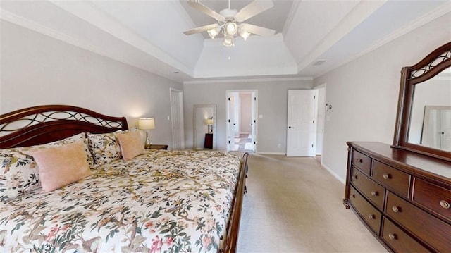bedroom featuring light colored carpet, baseboards, a tray ceiling, a ceiling fan, and crown molding