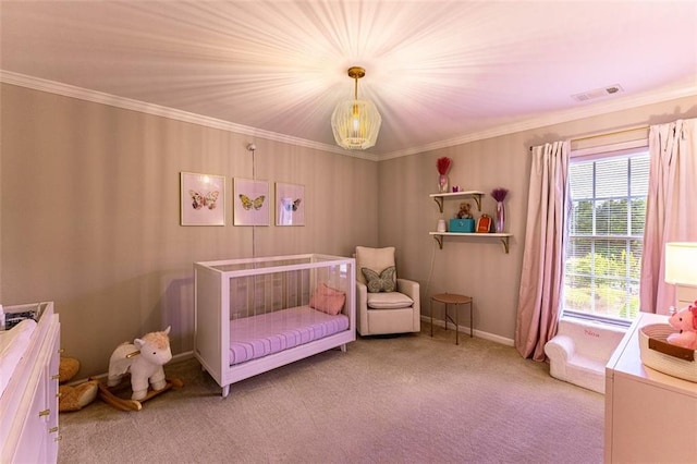 carpeted bedroom with crown molding and a nursery area