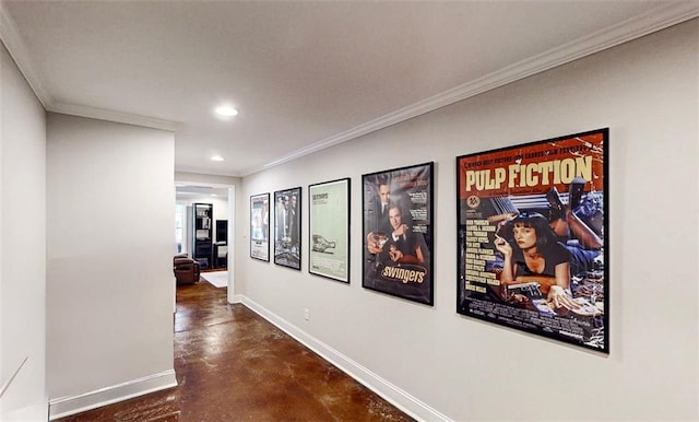 corridor with finished concrete flooring, recessed lighting, baseboards, and crown molding