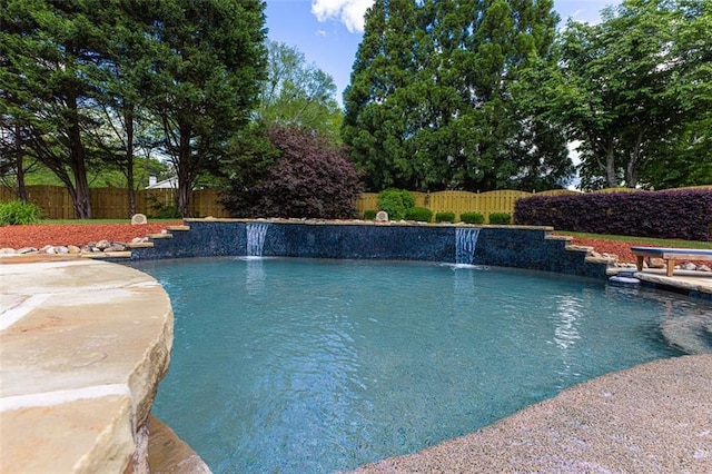 view of swimming pool with a fenced backyard