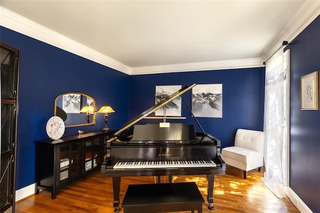 living area with wood finished floors, ornamental molding, and baseboards