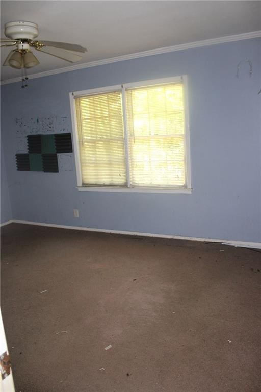 unfurnished room featuring crown molding, ceiling fan, carpet flooring, and baseboards
