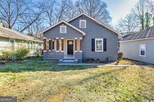 bungalow-style home with a front yard