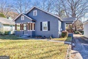 bungalow-style home with a front yard and a porch