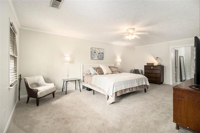 bedroom featuring ceiling fan, ornamental molding, light carpet, and a textured ceiling