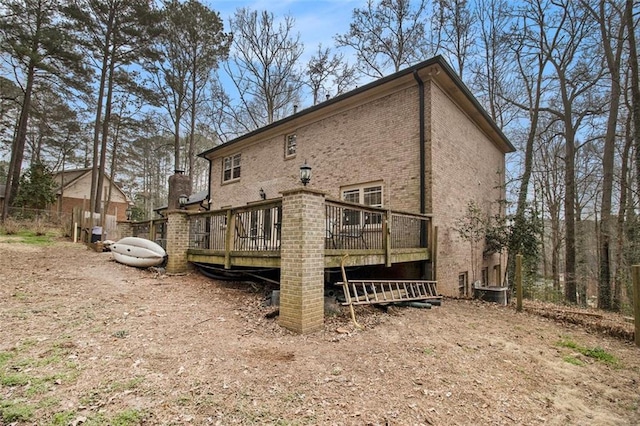 rear view of house featuring a deck