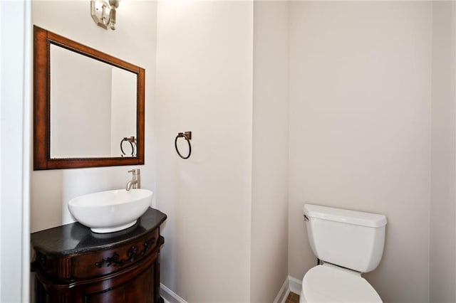 half bathroom featuring toilet and vanity