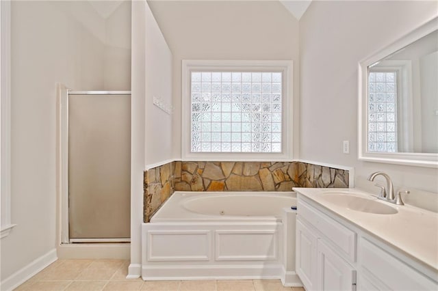 full bath with tile patterned floors, a shower stall, vanity, and a garden tub